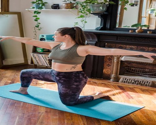 Woman performing gentle yoga stretches in a living room